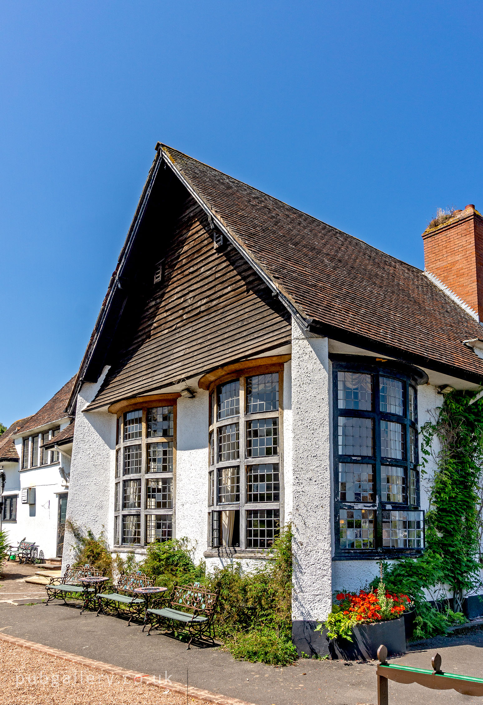 Left exterior with tall convex curved windows.  by D. Kennedy. Published on 